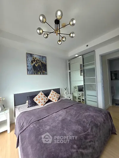 Modern bedroom with stylish decor and ample natural light