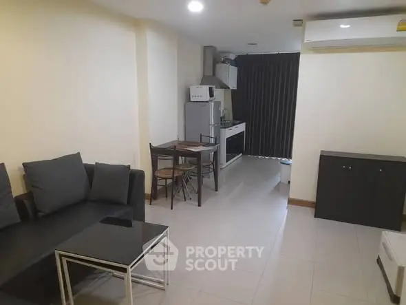 Modern living room with open kitchen and sleek furnishings