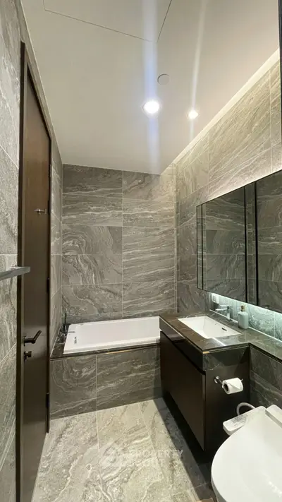 Luxurious modern bathroom with elegant stone tiles and sleek fixtures