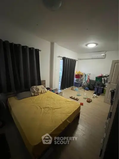 Cozy bedroom with large bed and ample storage space, perfect for comfortable living.