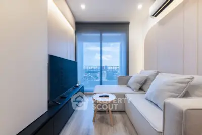 Modern living room with sleek furniture and city view from balcony, perfect for urban living.