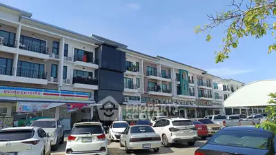 Modern commercial building with parking and retail shops in vibrant area