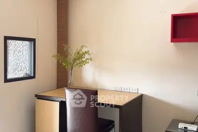 Modern study room with sleek desk and stylish chair, perfect for productivity.