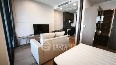 Modern studio apartment with open layout, featuring a cozy living area and compact kitchen.