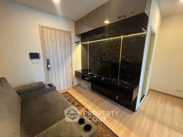 Modern living room with sleek black entertainment center and cozy seating