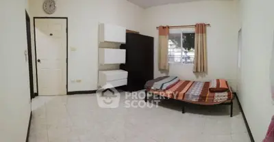 Cozy bedroom with simple furnishings and natural light