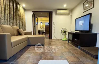 Cozy living room with modern decor and open view to dining area