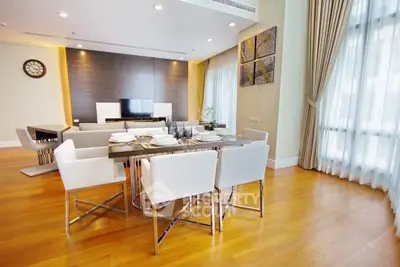 Luxurious modern living room with elegant dining area and wooden flooring.