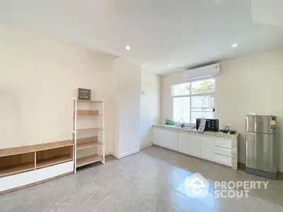 Spacious modern kitchen with sleek white cabinets and ample natural light