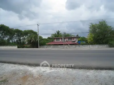 Charming countryside house with lush greenery and spacious surroundings.