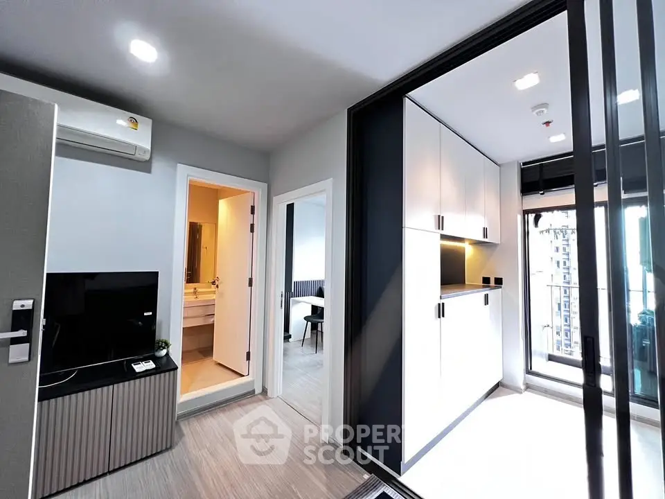 Modern apartment interior with sleek design, featuring a spacious living area and stylish kitchen.