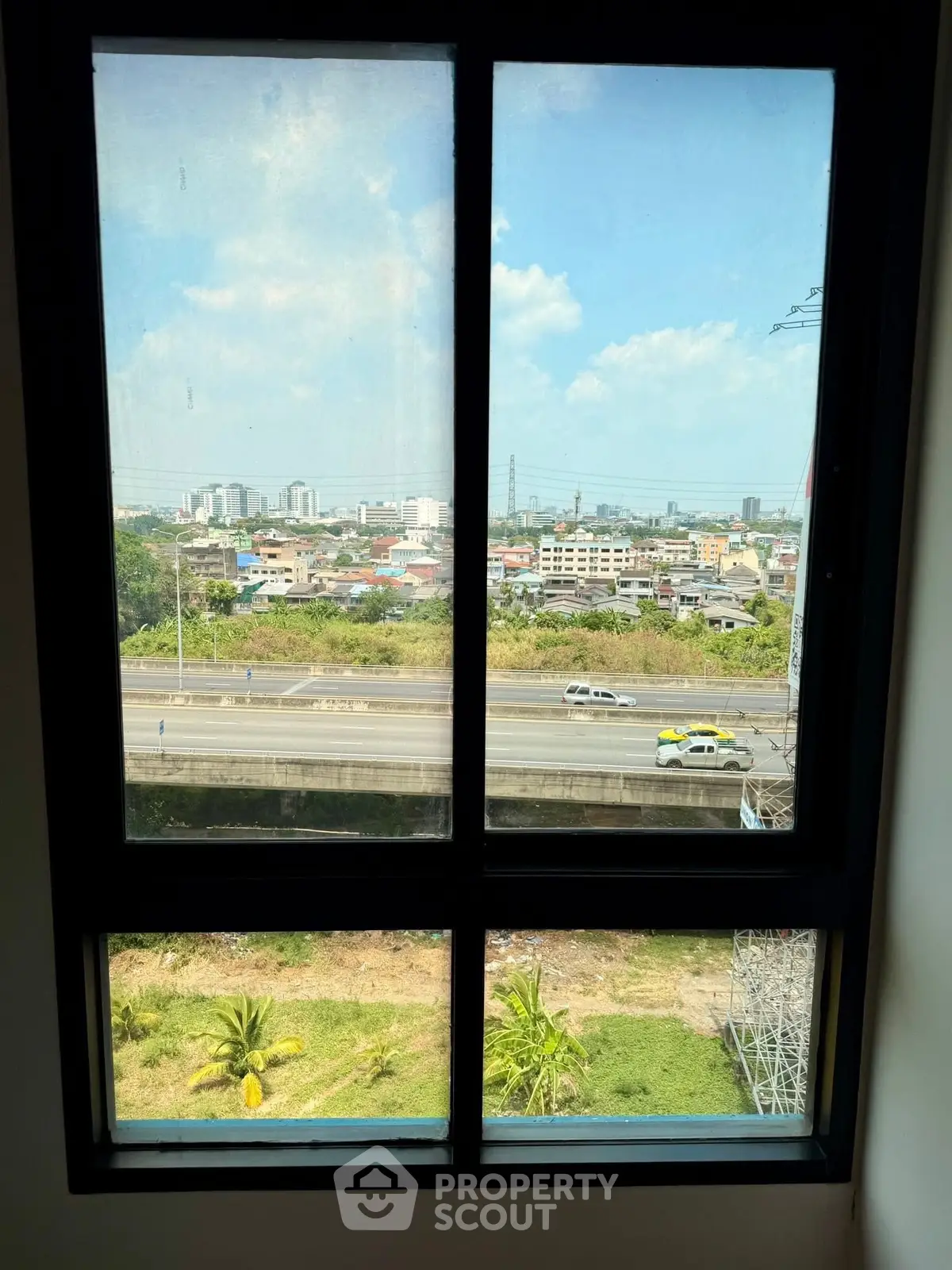 Stunning cityscape view from a modern apartment window, showcasing urban living with expansive skyline.