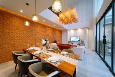 Stunning modern living room with high ceilings and elegant dining area, featuring stylish lighting and contemporary decor.