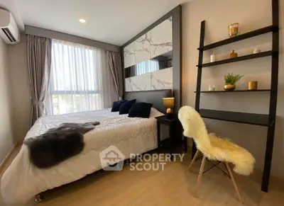 Modern bedroom with stylish decor and natural light, featuring a cozy bed and elegant shelving.