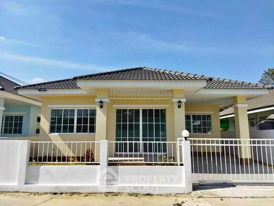 Charming single-story home with modern design and spacious front yard.