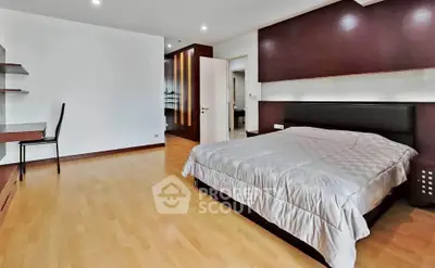 Spacious modern bedroom with wooden flooring and stylish decor