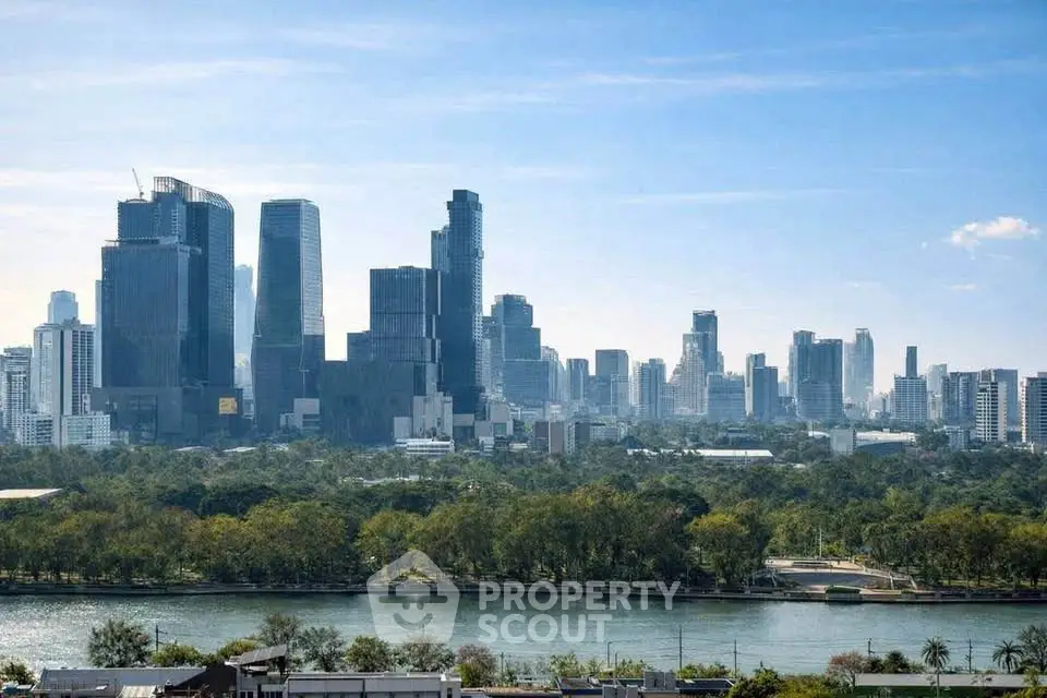 Stunning city skyline view with lush greenery and river in the foreground, perfect for urban living.