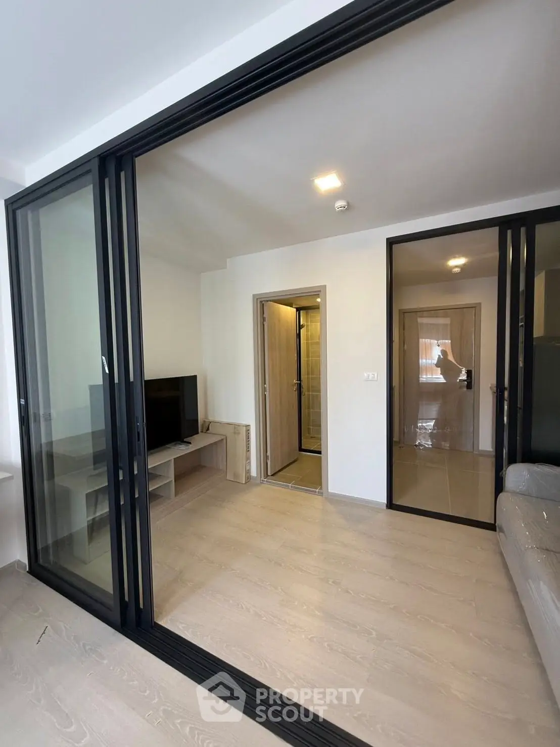 Modern living room with sliding glass doors and sleek interior design.