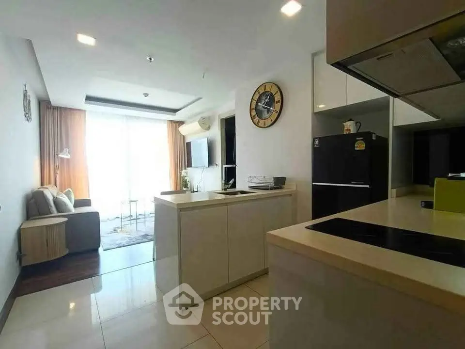 Modern open-layout kitchen and living room with sleek design and natural light.