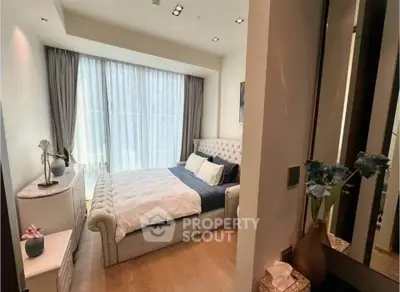 Luxurious bedroom with elegant decor and large window offering natural light
