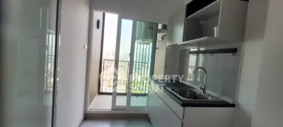 Modern kitchen with sleek design and balcony view in urban apartment