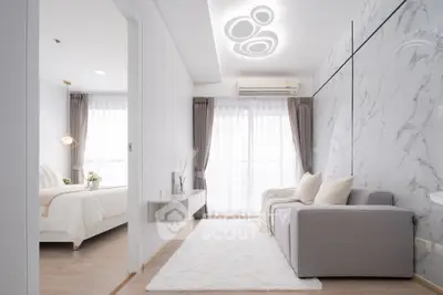 Modern living room with elegant marble accent wall and cozy gray sofa