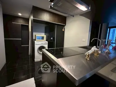 Modern kitchen with sleek appliances and washing machine in stylish apartment
