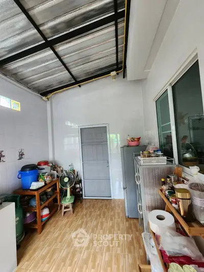 Spacious kitchen with tiled flooring and ample storage space, featuring modern appliances and natural light.