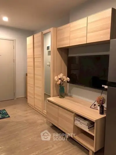 Modern living room with sleek wooden furniture and built-in TV unit, perfect for stylish urban living.