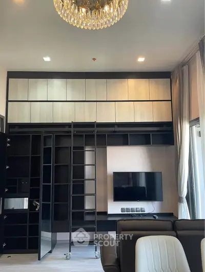 Luxurious living room with modern built-in shelving and elegant chandelier
