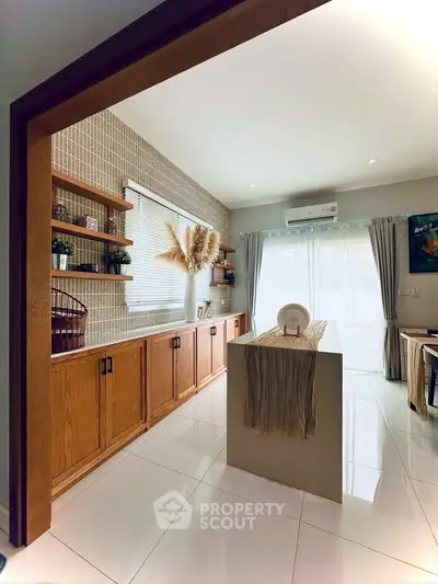 Stylish modern living room with natural light, wooden accents, and elegant decor.