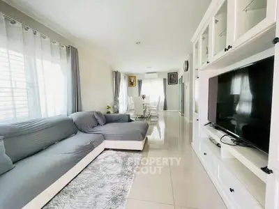 Spacious living room with modern decor and large windows for natural light.