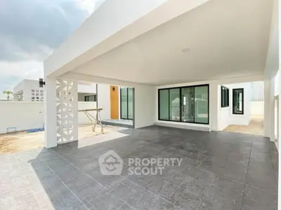 Modern open-air patio with sleek design and spacious layout, perfect for outdoor gatherings.