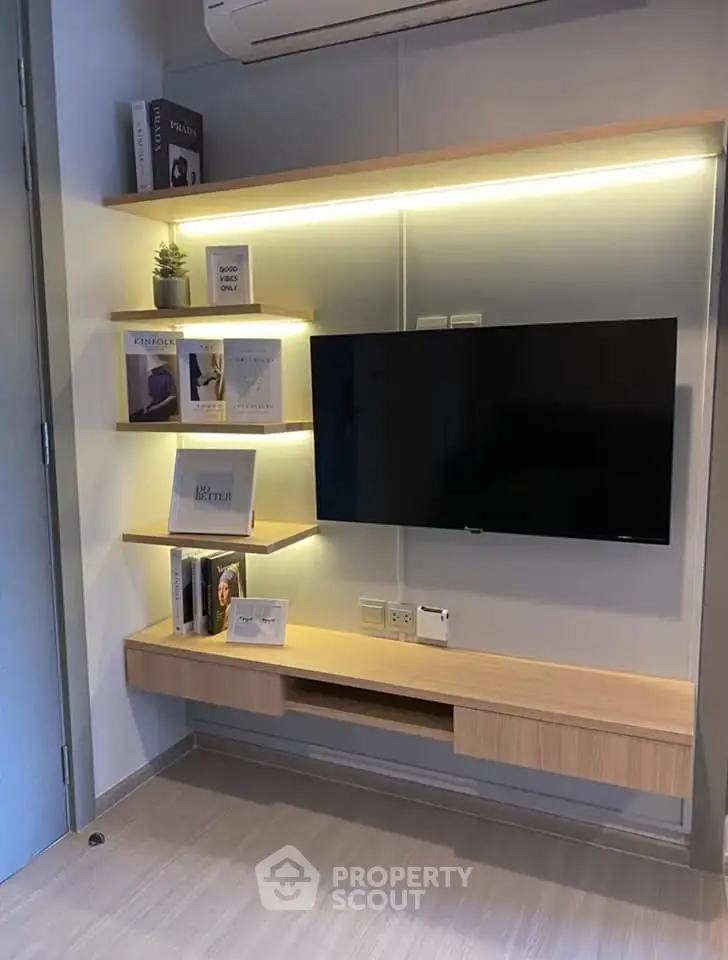 Modern living room with wall-mounted TV and ambient lighting, featuring sleek wooden shelves and a minimalist design.