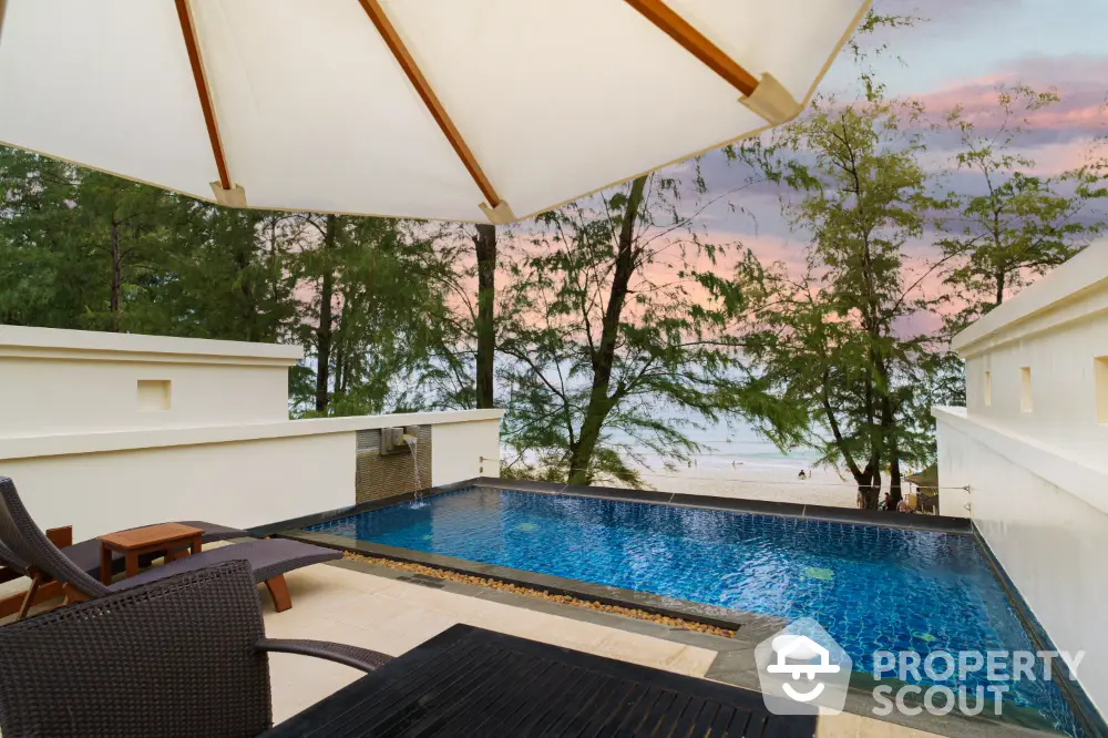 Luxurious beachfront property with private pool and stunning sunset views, perfect for relaxation and leisure.