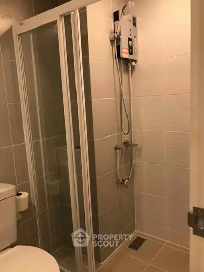 Modern bathroom with sleek shower enclosure and tiled walls