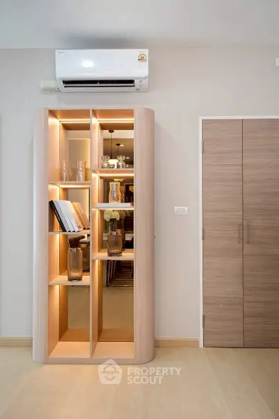 Modern interior with stylish wooden bookshelf and air conditioning unit, perfect for contemporary living spaces.