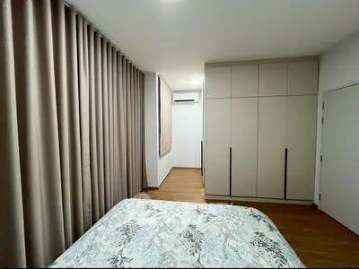 Spacious bedroom with modern wardrobe and elegant curtains, perfect for a cozy retreat.
