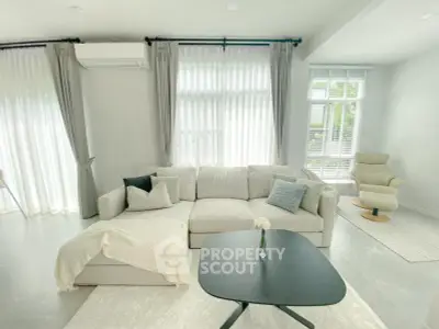 Bright and spacious living room with modern furniture and large windows