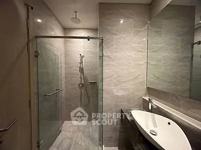 Modern bathroom with glass shower enclosure and sleek sink design