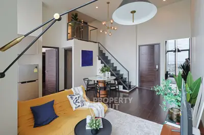 Modern duplex living room with stylish decor and open staircase