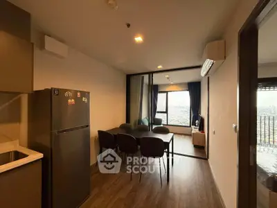 Modern apartment with open layout, featuring dining area and stunning city view.