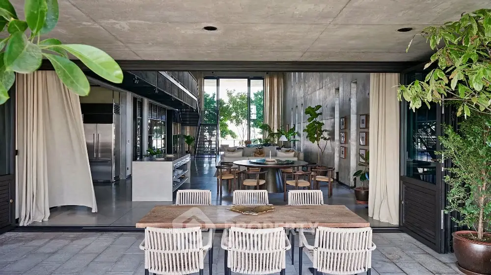 Stunning open-plan dining area with lush greenery and modern design elements.