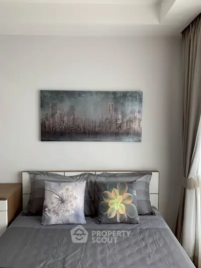 Modern bedroom with stylish decor and cityscape artwork above bed