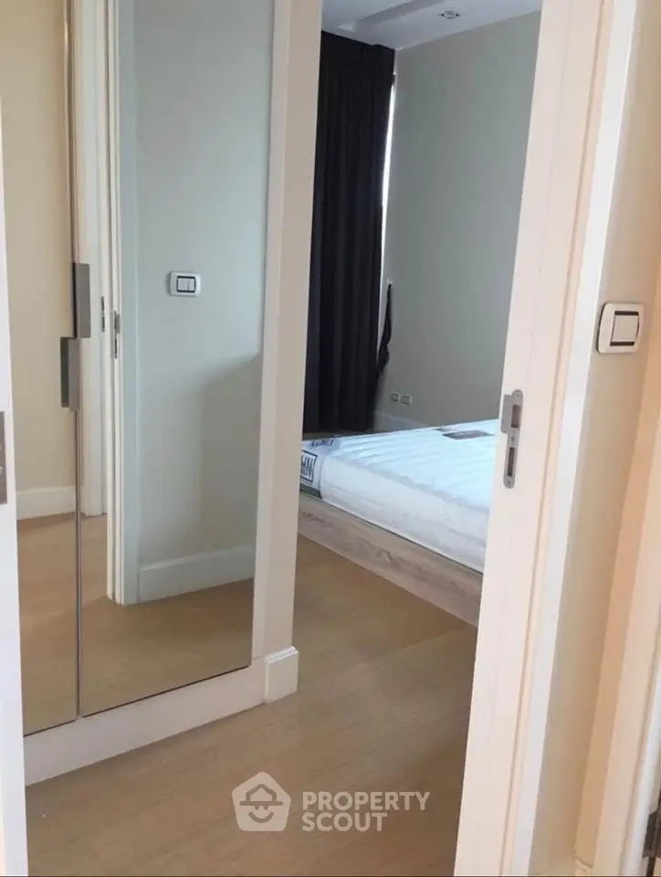 Modern bedroom with mirrored closet doors and sleek design