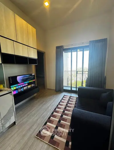 Modern living room with sleek TV setup and balcony view