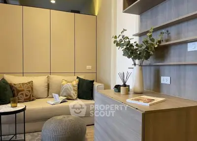 Modern living room with cozy sofa, stylish decor, and elegant shelving in a contemporary apartment.