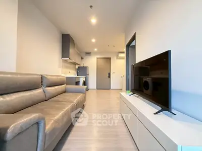 Modern living room with sleek furniture and open kitchen layout