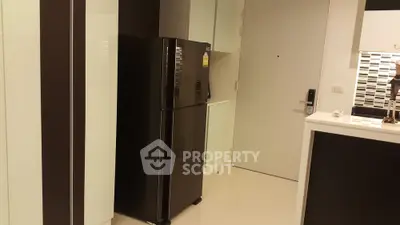 Modern kitchen with sleek black refrigerator and stylish cabinetry