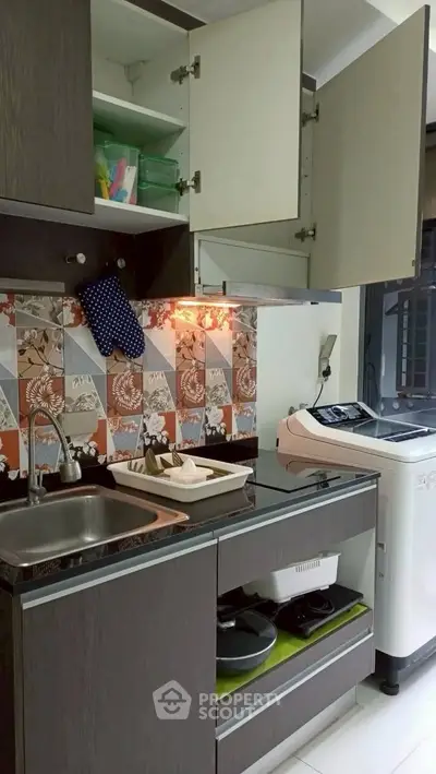 Modern kitchen with washing machine and stylish backsplash tiles